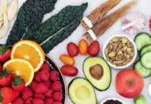 Anti-Inflammatory Diet: Tips And Benefits Looking down on a table filled with various different fruit and a bowl of oats representing a good anti-inflammatory diet option. There are also some vegetables like avocado which is also great for inflammation