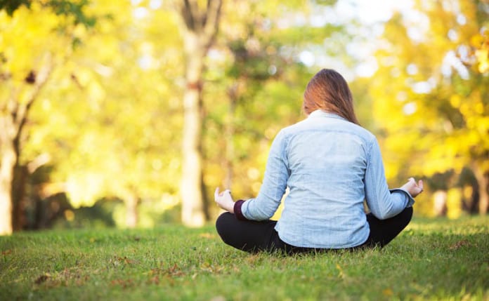 woman-yoga-pose-grass-park
