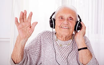 Senior Woman Enjoying Music With Headphone
